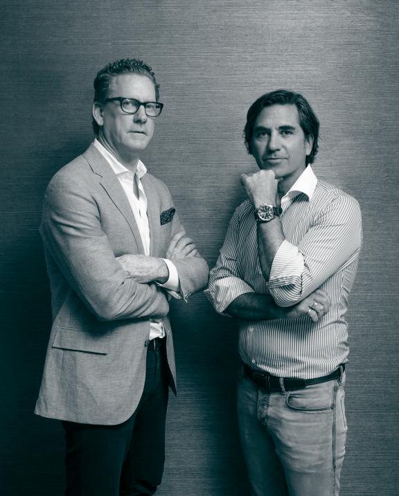 Two men pose for a picture
